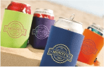 Custom can koozies holding drinks at the beach