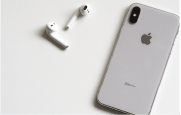 Apple AirPods wireless earbuds next to iPhone