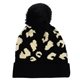 aerial view a black with black leopard print pom beanie, image 1 of 2