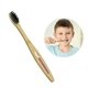 a wood handle with black bristles kids toothbrush