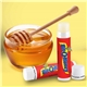 aerial view a honey promotional lip balm with natural beeswax formula, image 1 of 2