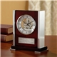 aerial view a rosewood/clear cronus visible mechanism clock, image 1 of 2