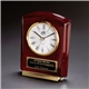 a group of polished rosewood cornell desk clock