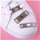 aerial view a group of 1.25 diestruck shoelace charm, image 1 of 4