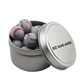 a silver round tin with chocolate baseballs
