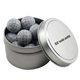 a silver round tin with chocolate golf balls
