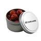 a silver round tin with chocolate basketballs