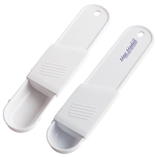 aerial view a white adjustable measuring spoon, image 1 of 3