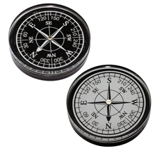 a group of large compass paperweight