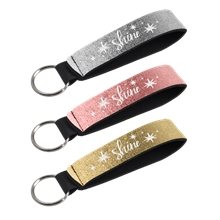 aerial view a group of metallic neoprene wrist strap key holder, image 1 of 2