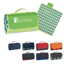 a group of roll - up picnic / beach blanket