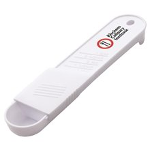 aerial view a white 5- in -1 sliding measuring spoon, image 1 of 2