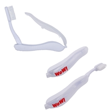 aerial view a white folding travel toothbrush, image 1 of 2