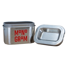 aerial view a silver 1 gram child resistant push tin, image 1 of 2