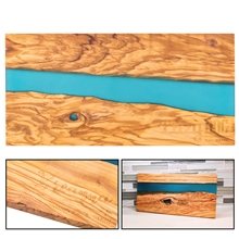 a group of long olive wood blue resin serving cutting board