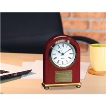 a group of jaff collection rosewood arch with brass bezel clock