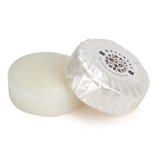 a white plastic wrapped round soap