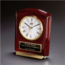a group of polished rosewood cornell desk clock