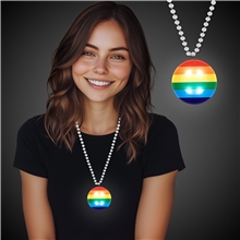 a group of rainbow pride light up round medallion