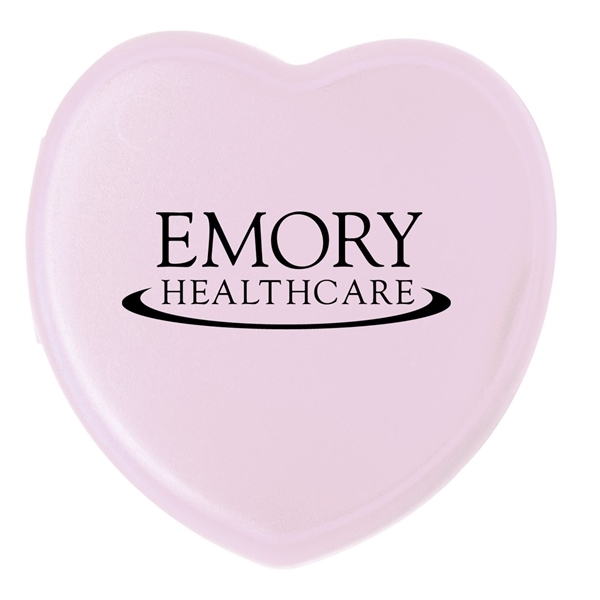 aerial view a translucent pink heart shaped pill box, image 2 of 2