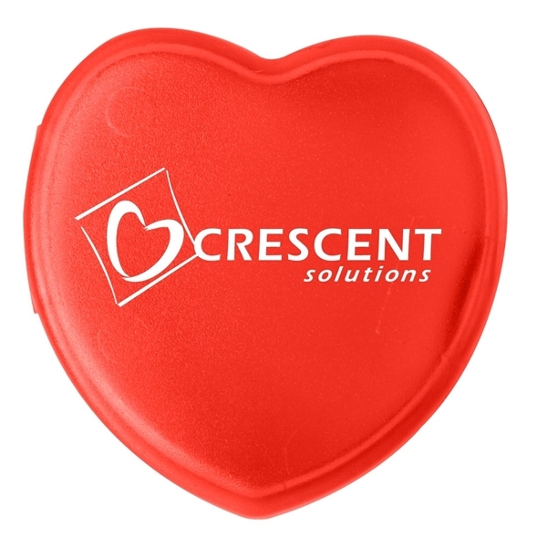aerial view a translucent red heart shaped pill box, image 2 of 2